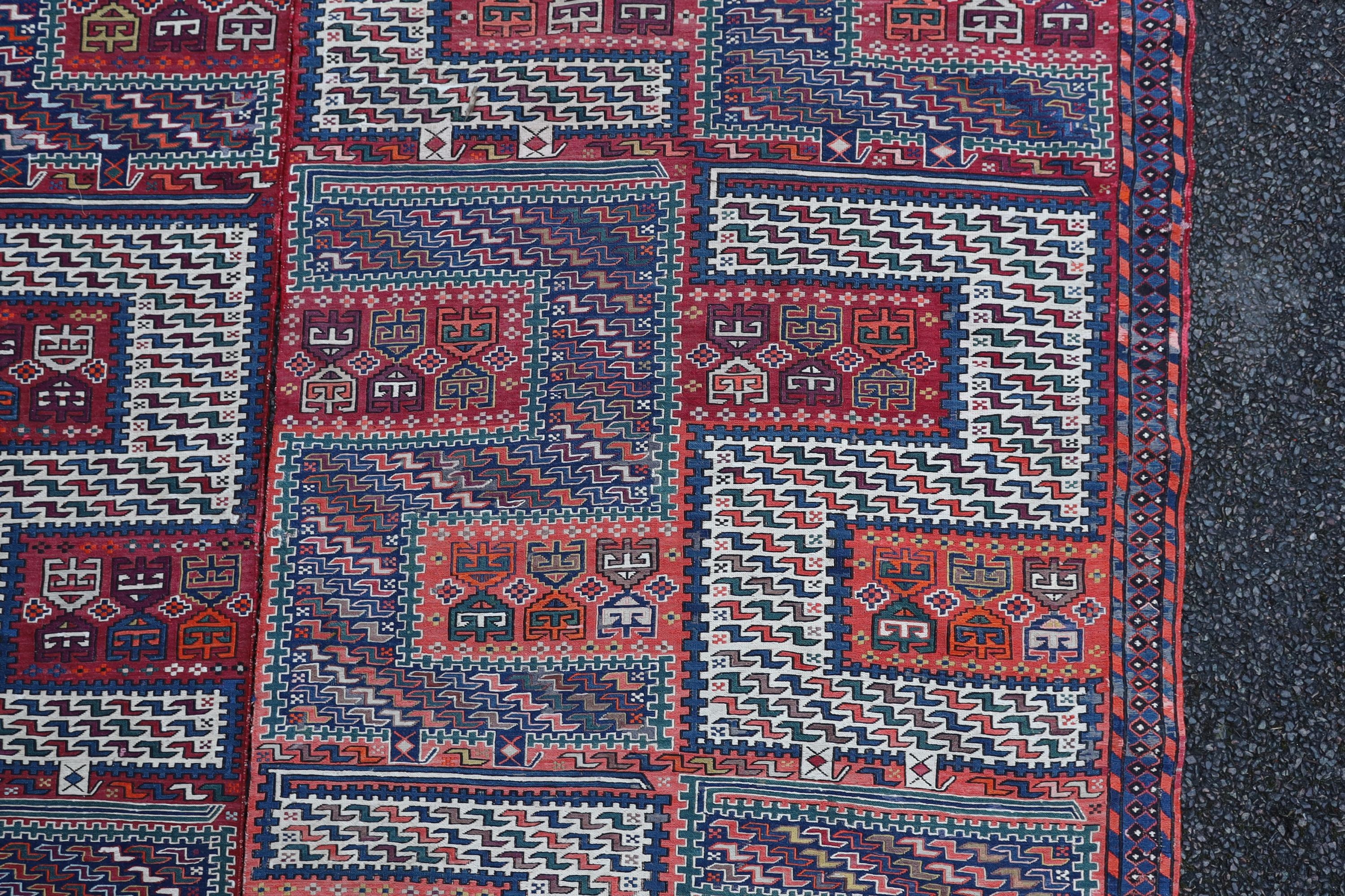A Sumak weave 2-sectional carpet, combined dimension - 320 x 230cm.